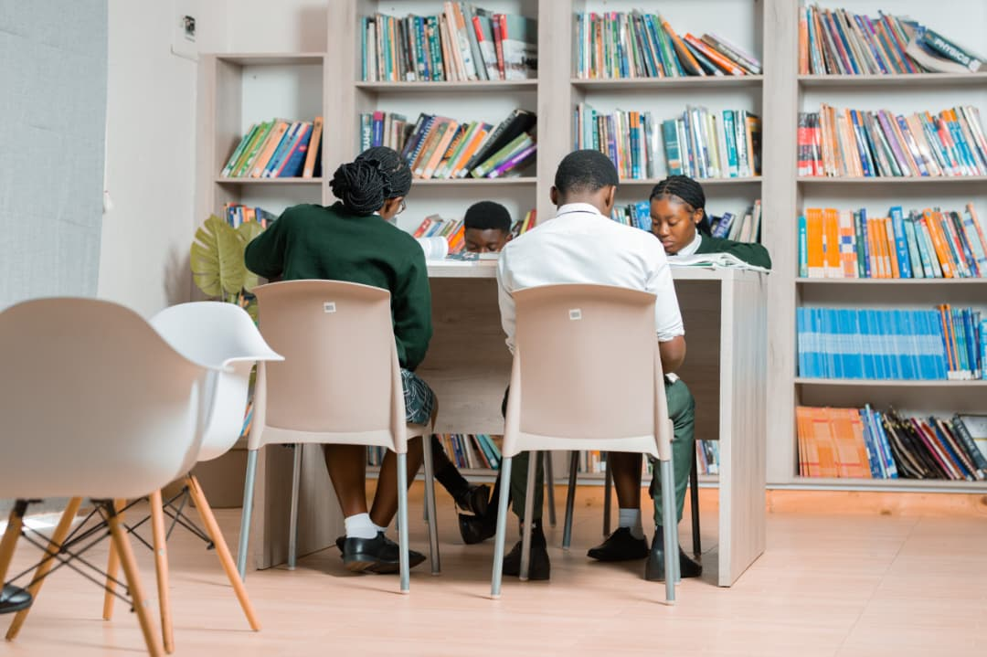 Two primary learners reading together in the school library